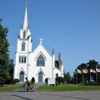 Cycling along a peaceful road, discovering a historic church tucked away in the landscape | Nathalie Gauthier